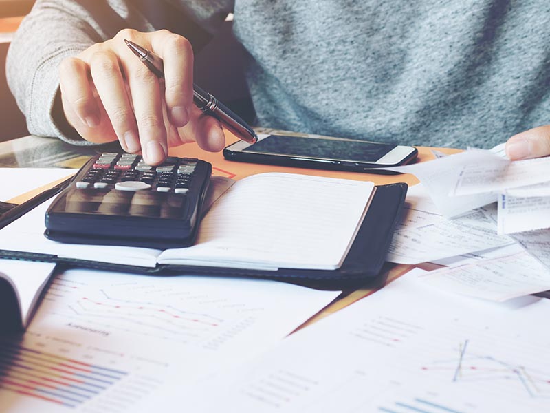man calculating paper work receipts