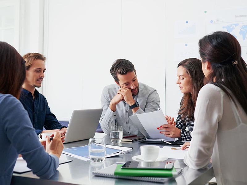group discussing office move planning in conference room