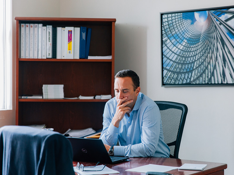 corporate employee looking at laptop