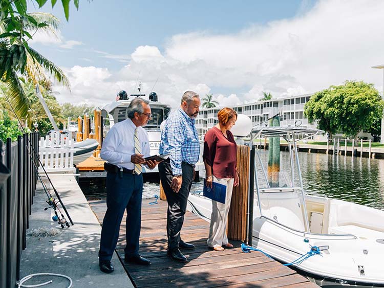 couple and moving coordinator discussing boat transport