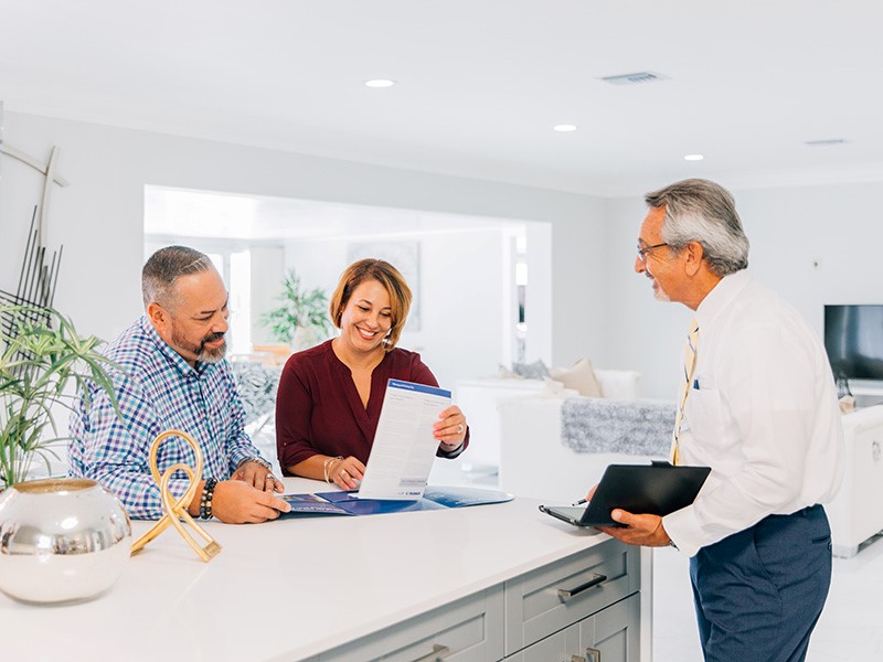 couple discussing international move forms with move coordinator