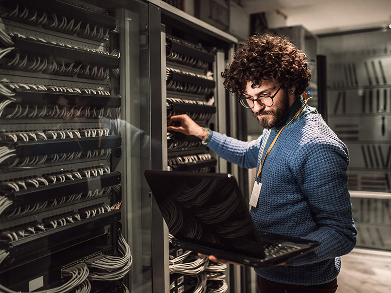 man using laptop to work on data center move