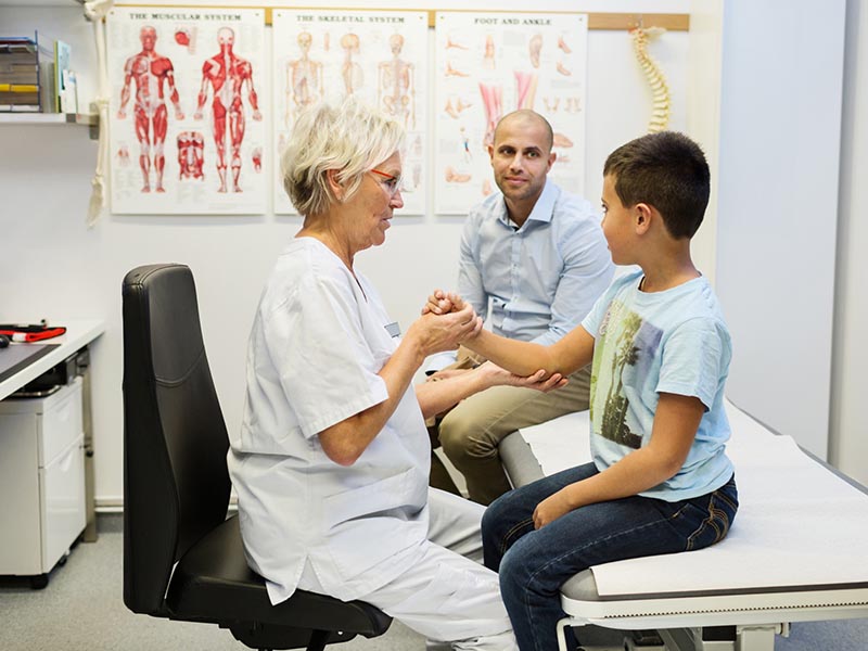 father and son in office for doctor visit