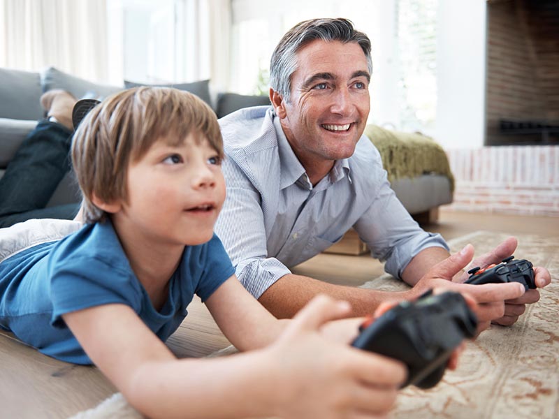father and son playing video games