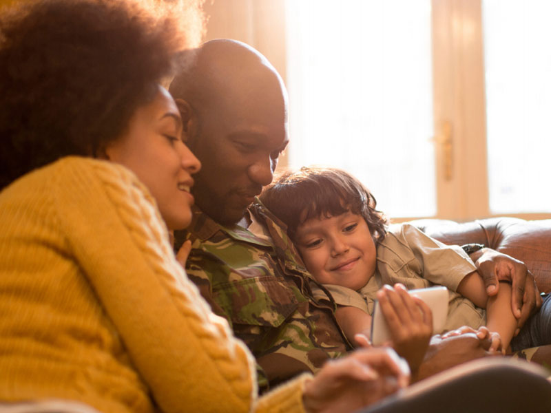 military parent spending time with family on couch