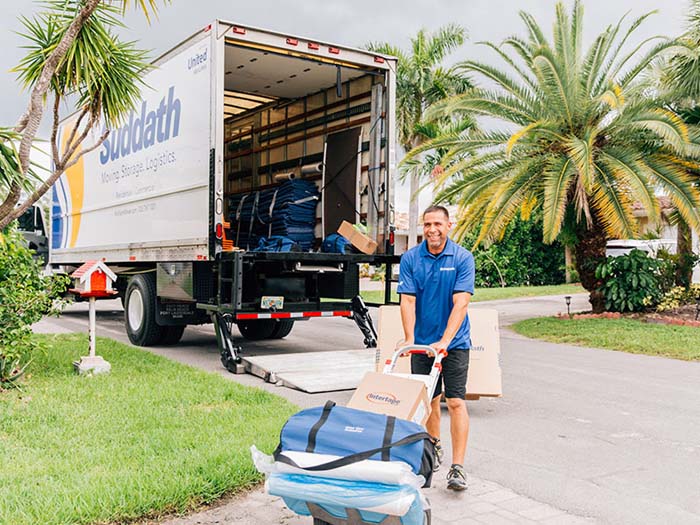miami local mover pushing dolly with moving supplies