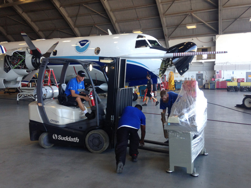 suddath workers moving noaa machinery