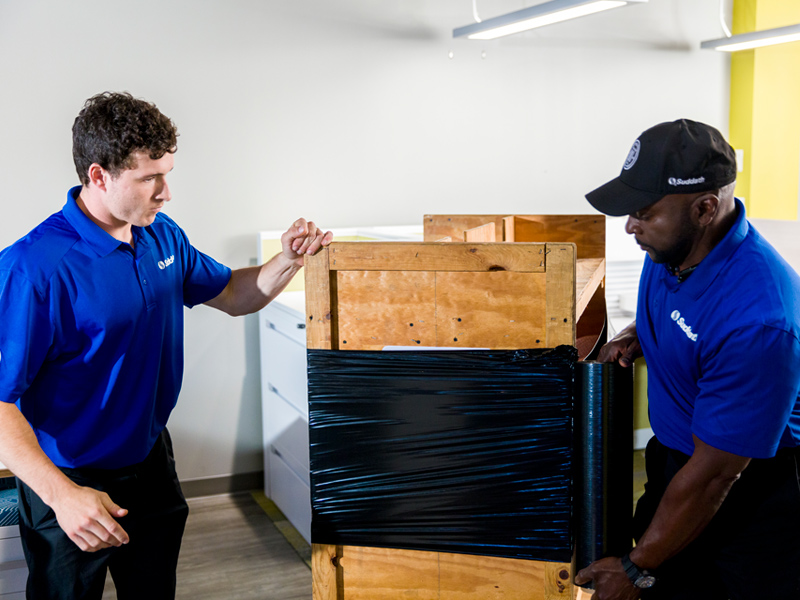 movers wrapping office furniture