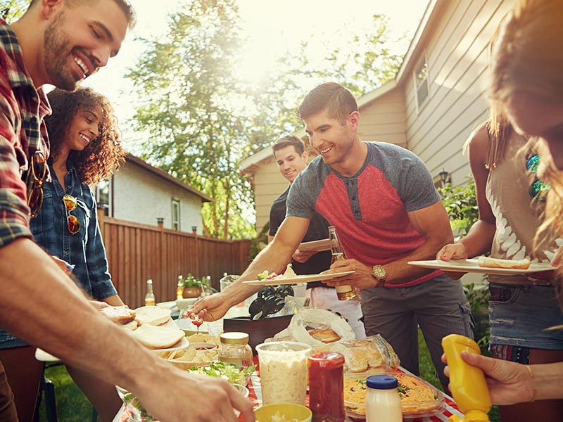 friends getting food at post move cookout