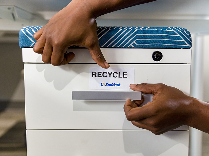 office mover placing recycle tag on office furniture