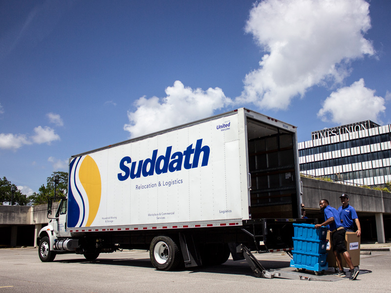 office movers loading boxes on moving truck during times union move