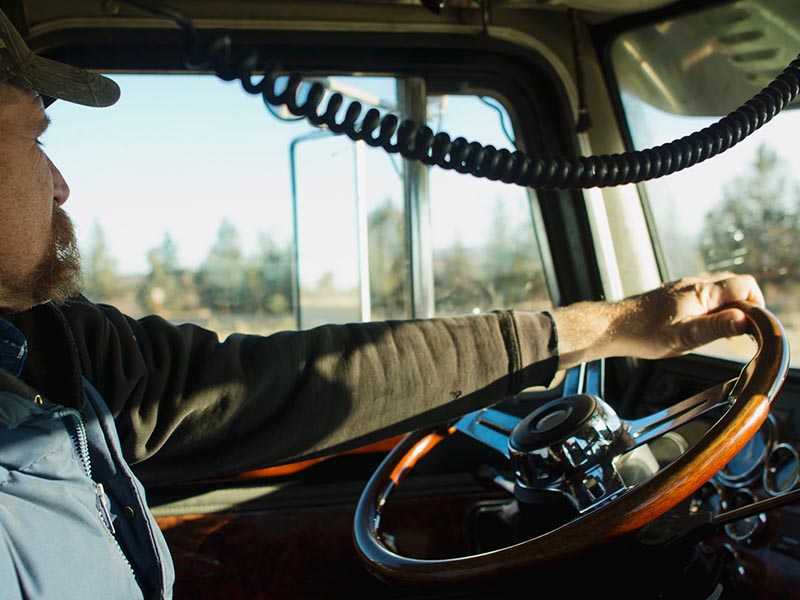 truck driver at wheel in moving truck