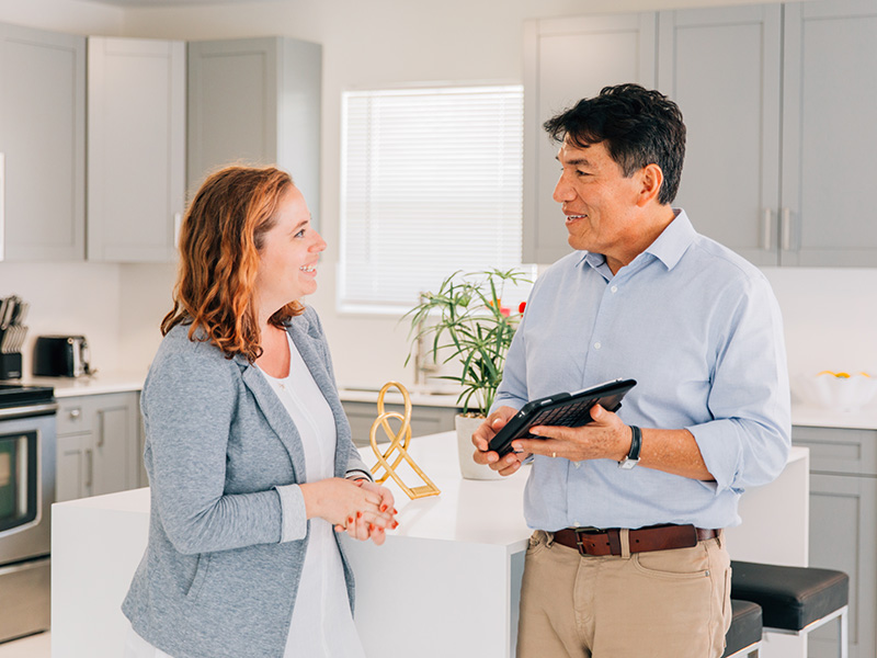 move coordinator talking with woman in kitchen
