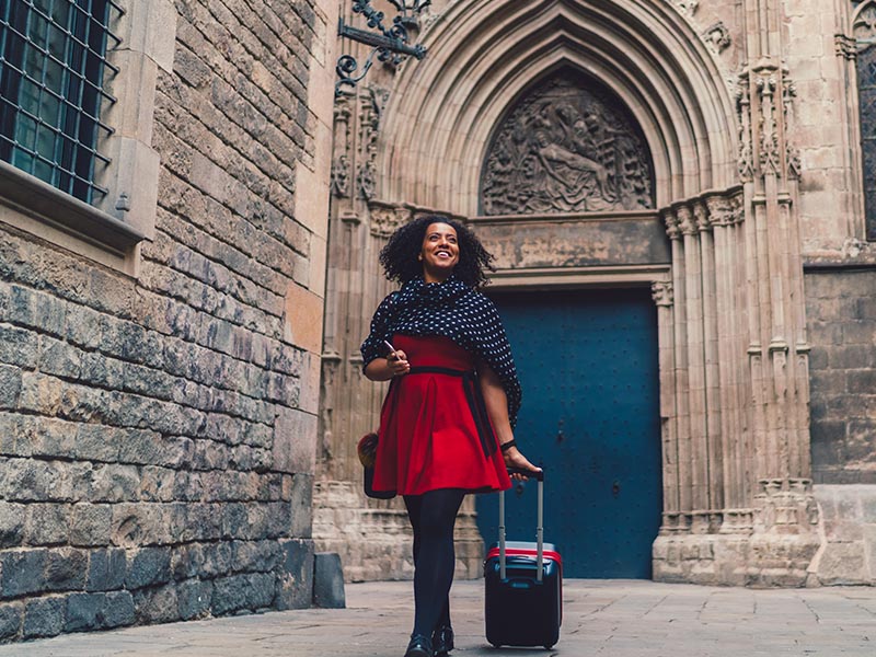 woman walking with luggage in europe