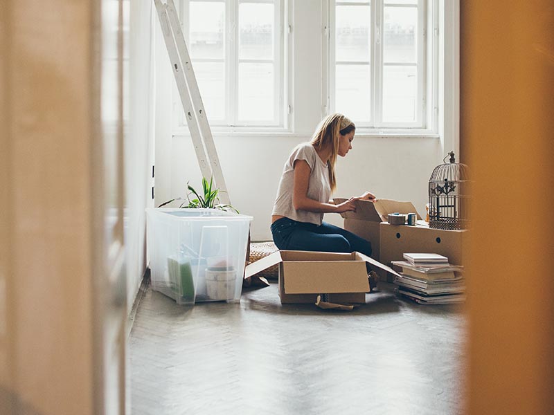 woman packing moving boxes in home